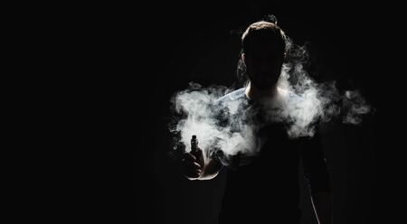 Vaping flavored e-liquid from an electronic cigaretteの写真素材