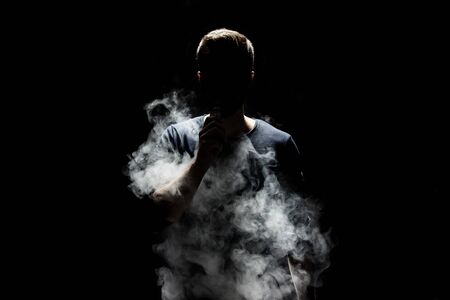 Vaping flavored e-liquid from an electronic cigaretteの写真素材