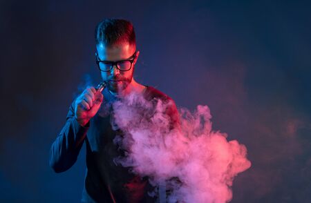 Vaping flavored e-liquid from an electronic cigaretteの写真素材