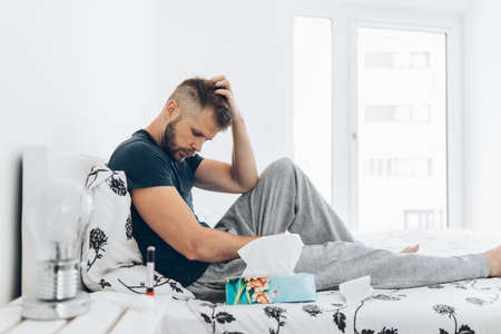 Young man in home quaratine after positive Covid 19 testの写真素材