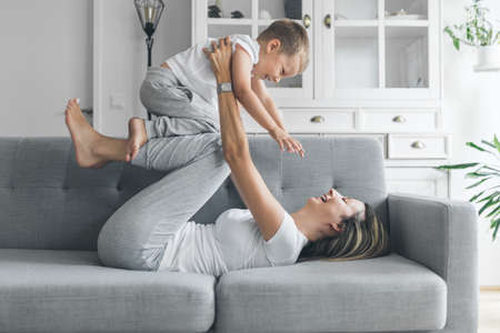 Mother with her son on a sofa in their living roomの写真素材