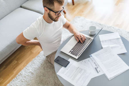 Man working from home during the coronavirus Covid 19 pandemicの写真素材