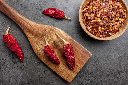Variety of fresh and dried chili peppers on rustic backgroundの写真素材
