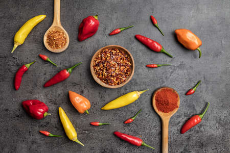 Variety of fresh and dried chili peppers on rustic backgroundの写真素材