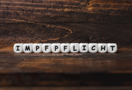 Corona virus Covid-19 vaccine text in German on wooden backgroundの写真素材