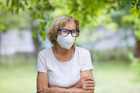 Elderly woman wearing a protective face mask against corona virus