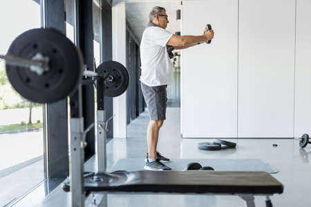 Active and healthy senior exercising in a gym