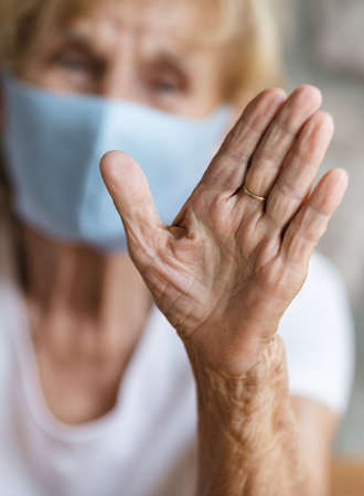 Elderly woman with a face mask during lockdownの写真素材