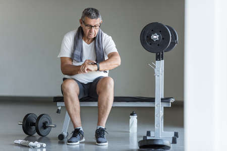 Active and healthy senior exercising in a gymの写真素材
