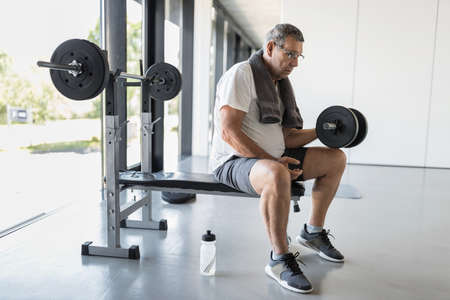 Active and healthy senior exercising in a gymの写真素材