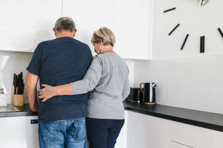 Happy romantic senior couple in love cooking together at homeの写真素材
