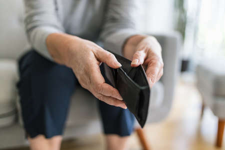 Desperate elderly woman unhappy with the rising cost of livingの写真素材
