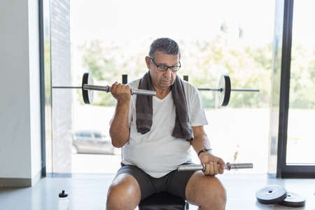 Active and healthy senior exercising in a gymの写真素材