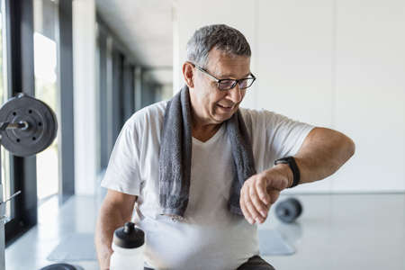 Active and healthy senior exercising in a gymの写真素材
