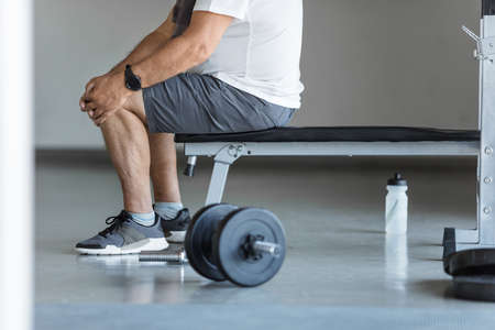 Active senior man in gym with knee injuryの写真素材