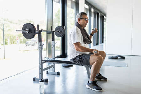 Active and healthy senior exercising in a gymの写真素材