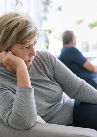 Upset senior couple at home in living room having an argumentの写真素材