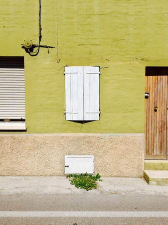 Wooden white window of a green house - Building façade (Pesaro, Italy)の写真素材