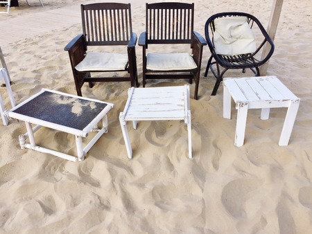 Chair, deck chair and table on the sand (Pesaro, Italy)の写真素材