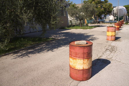 Red and yellow barrels on the street (Pesaro, Italy)の写真素材