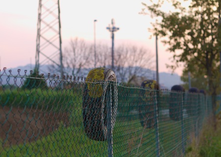 Tire on the wire mesh fence (Pesaro, Italy)の写真素材