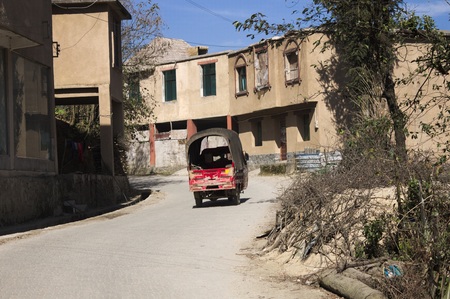 Red isolated pick-up on the street (Yuanyang, Yunnan, China)