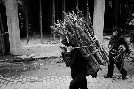 Duo Yi Shu Village, Yuanyang, Yunnan, China - 26 december 2017: A chinese woman is carrying the branches on her backのeditorial素材