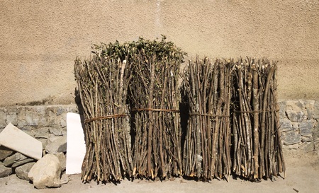 Branches tied and leaning against the wall (Yunnan, China)の写真素材