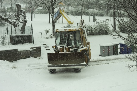 Snowplow on the snowy street (Pesaro, Italy)
