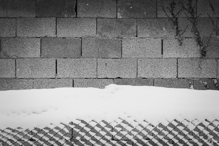 Brick background and snowy fence (Pesaro, Italy)の写真素材