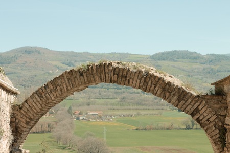 Round brick arch and an italian landscape (Spello, Umbria, Italy)の写真素材