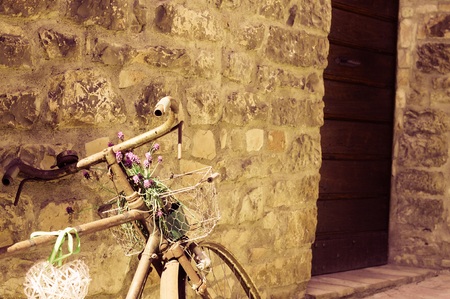 Isolated old bike with plants and flowers in the basket (Spello, Umbria, Italy)の写真素材