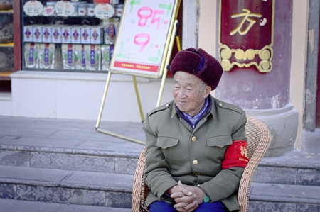 Kunming, Yunnan, China - 28 December 2017: An old chinese soldier is sitting outside the Yuantong Templeのeditorial素材