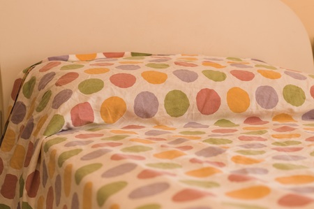 Bed and pillow with colored pois (Pesaro, Italy, Europe)