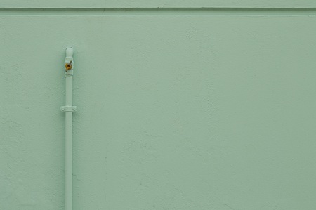 Little gas pipe on the light blue wall (Pesaro, Italy, Europe)の写真素材