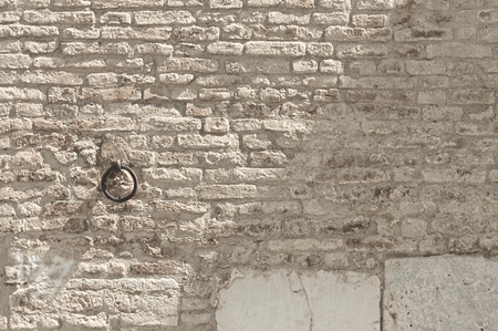 Isolated iron handle in a medieval wall background (Marche, Italy, Europe)の写真素材