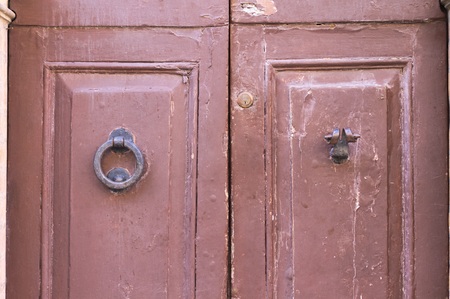 Red door handle and knocker (Pesaro, Italy, Europe)の写真素材