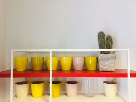 Yellow vases on a red shelf (Italy, Europe)の写真素材