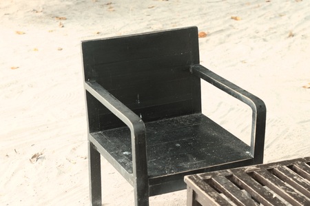 Isolated black chair on the sand (Ari Atoll, Maldives)の写真素材