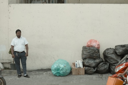Male, Maldives - 20 December 2018: Isolated man near trash bagsのeditorial素材