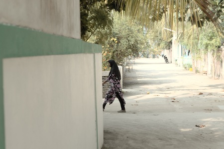 Ari Atoll, Maldives - 24 December 2018: Isolated veiled woman on the streetのeditorial素材