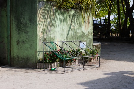 Typical maldivian seats in front of the house with palm treesの写真素材