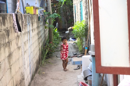 Ari Atoll, Maldives - 24 December 2018: A child with a red dress is playing outdoorのeditorial素材