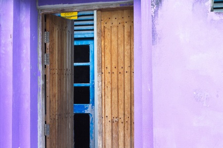 Entrance of a violet house with a wooden door (Ari Atoll, Maldives)の写真素材