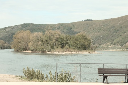 Isolated bench near the river Rhine (Bacharach, Germany, Europe)