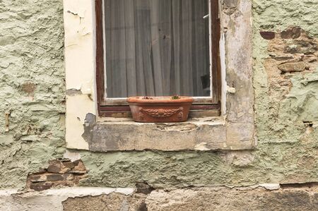Isolated pot out of the window in an abandoned houseの写真素材