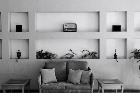 Vintage and minimal interiors with a retro sofa and an old radio on the wall (Madeira, Portugal)の写真素材