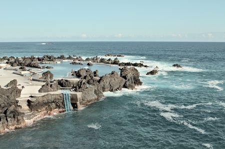 Porto Moniz, Madeira, Portugal - August 24, 2019: Panoramic view of natural pools surrounded by black volcanic rock.のeditorial素材