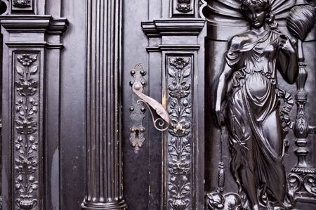 Iron handling of a decorated black door with bas-reliefs (Prague, Czech Republic, Europe)のeditorial素材