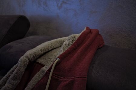 Isolated sweater with fur and with hood on the sofa (Pesaro, Italy, Europe)の写真素材